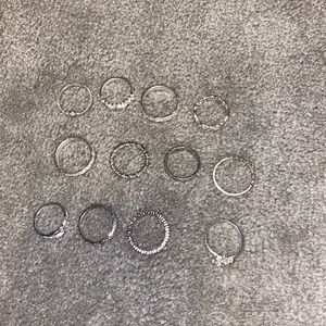 12 silver rings. Sizes vary 5-9